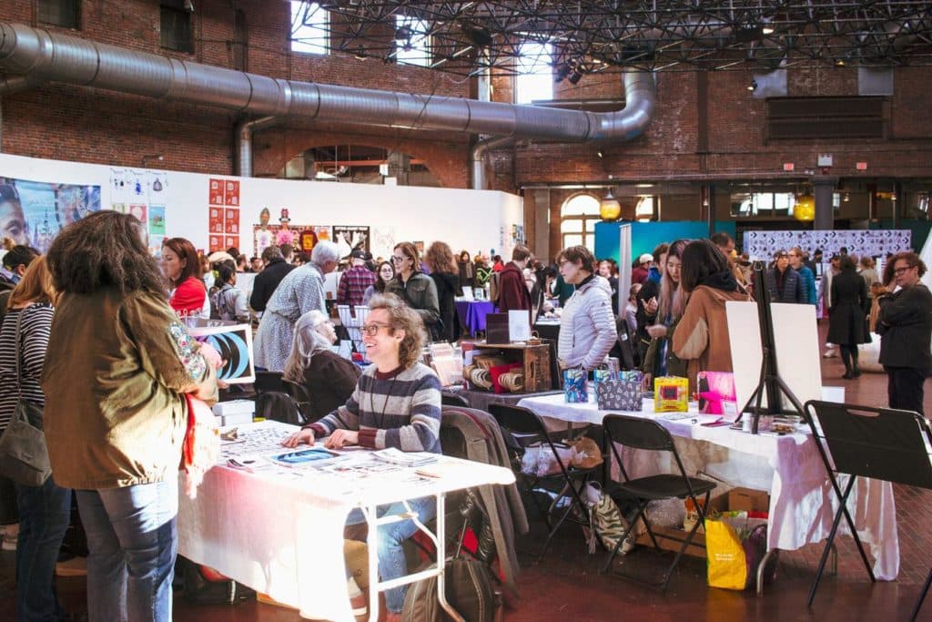 Tables set up by exhibitors at the Boston Art Book Fair.