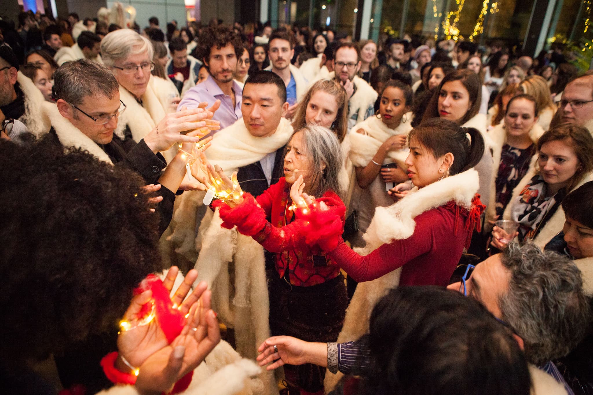 During a performance at the Museum of Fine Arts, a crowd of people gathers around in a celebratory rebirthing of the lost art of the quipu.