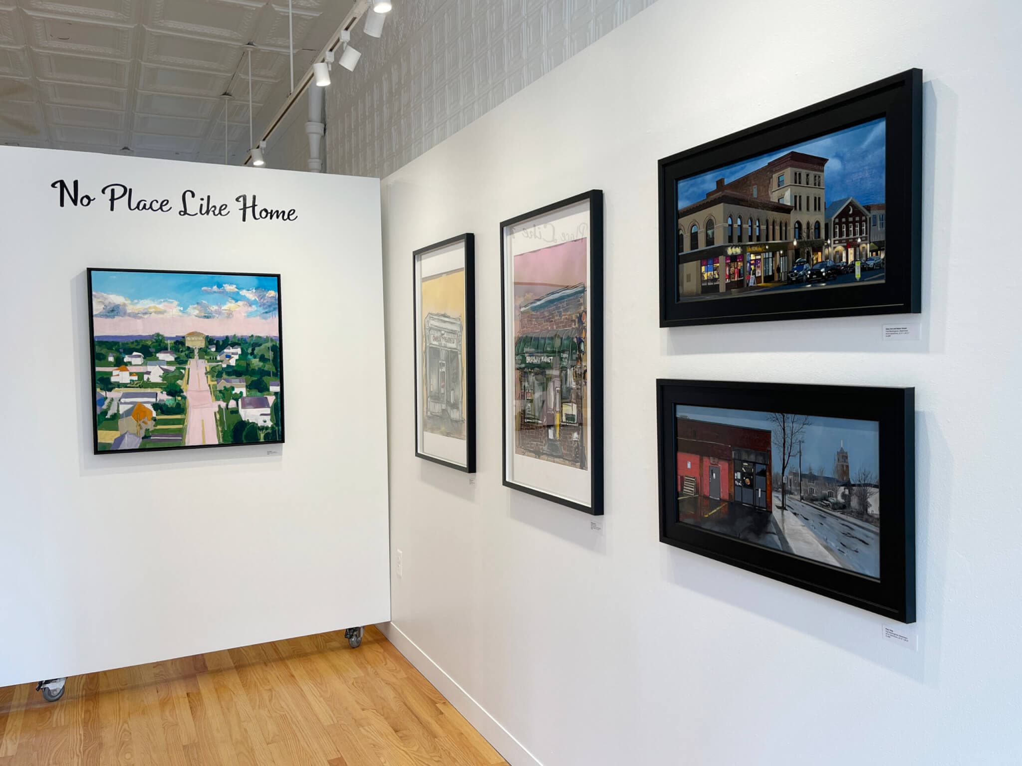 Gallery view of exhibition of painted postcards.